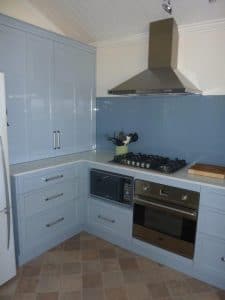 Blue kitchen cabinets and splash back in a home kitchen