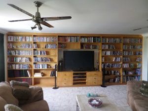 A large built in bookcase in a living room