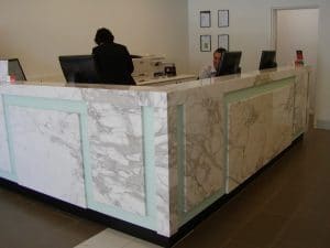 A white marble reception counter at an office