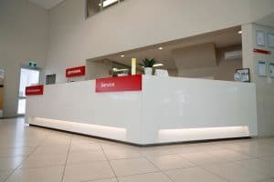 A large white gloss reception desk at a Toyota dealership in Rockhampton