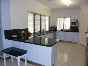 A custom kitchen with dark laminate bench top in a Rockhampton home
