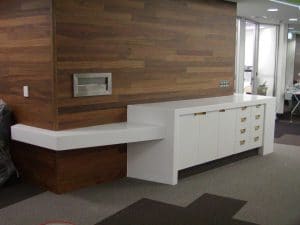 Custom made white reception drawers and bench