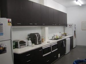 A large dark custom kitchen in an office in Rockhampton