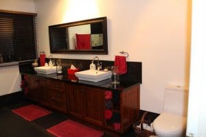 A dark custom kitchen vanity with double sink