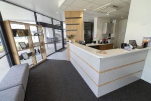 A custom reception desk at the entrance of an office